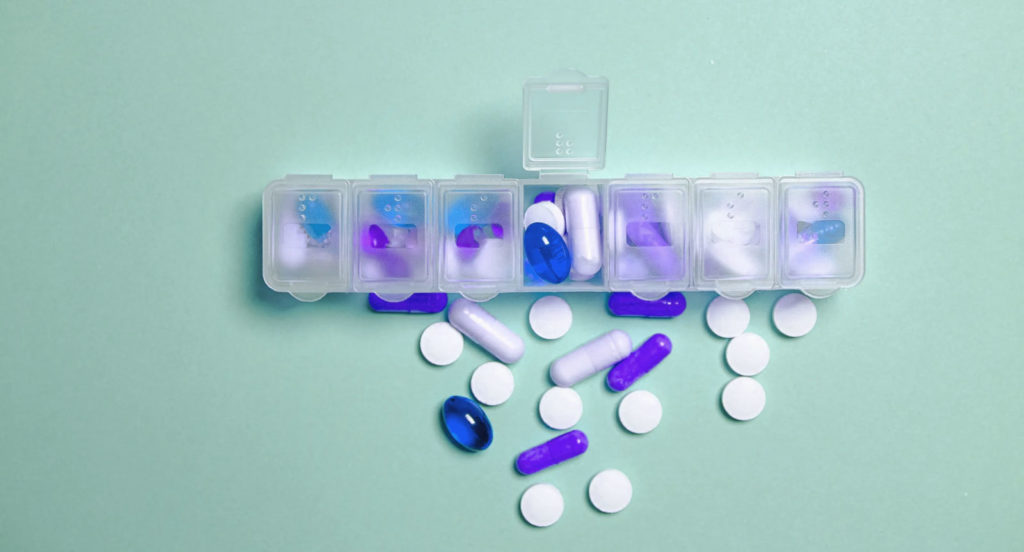 a container for daily pills containing blue and white medication