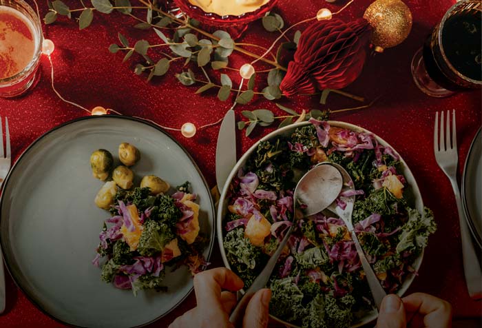 a table decorated with festive decor and a salad