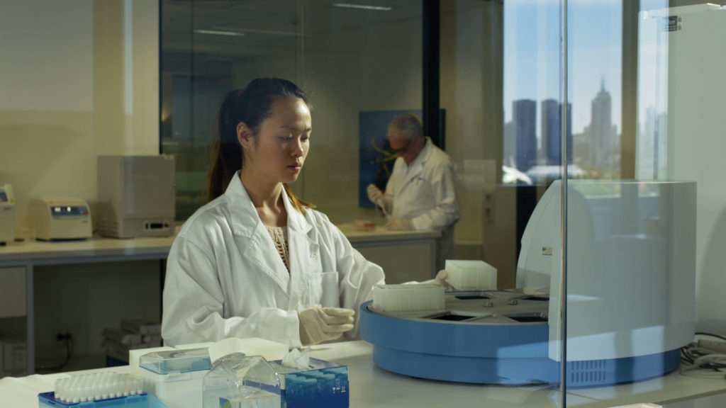 A female scientist in a white gown at the myDNA Laboratory