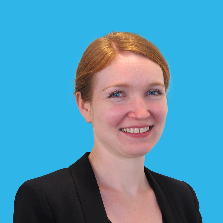 tara-smith-portrait a portrait of Tara Smith on a blue background