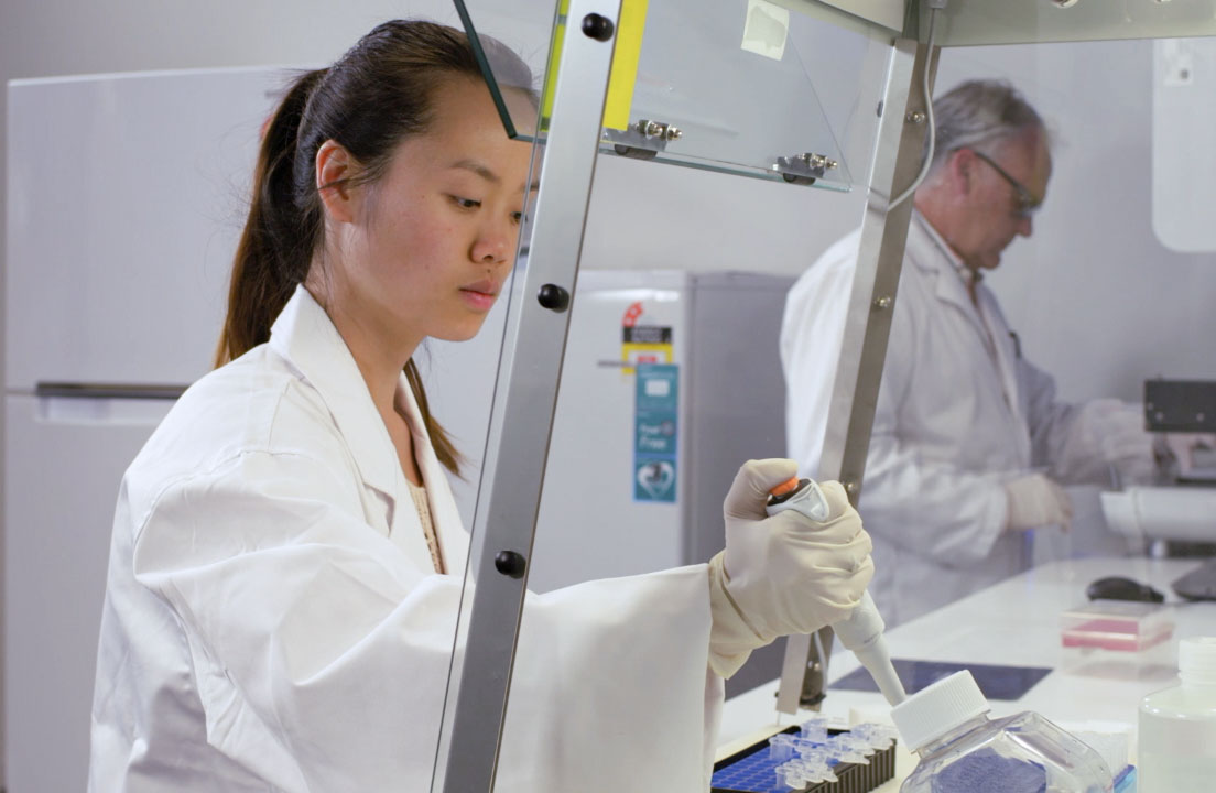 mydna-lab-staff-pipetting-samples myDNA scientists in the laboratory pipetting samples in a ventilated chamber