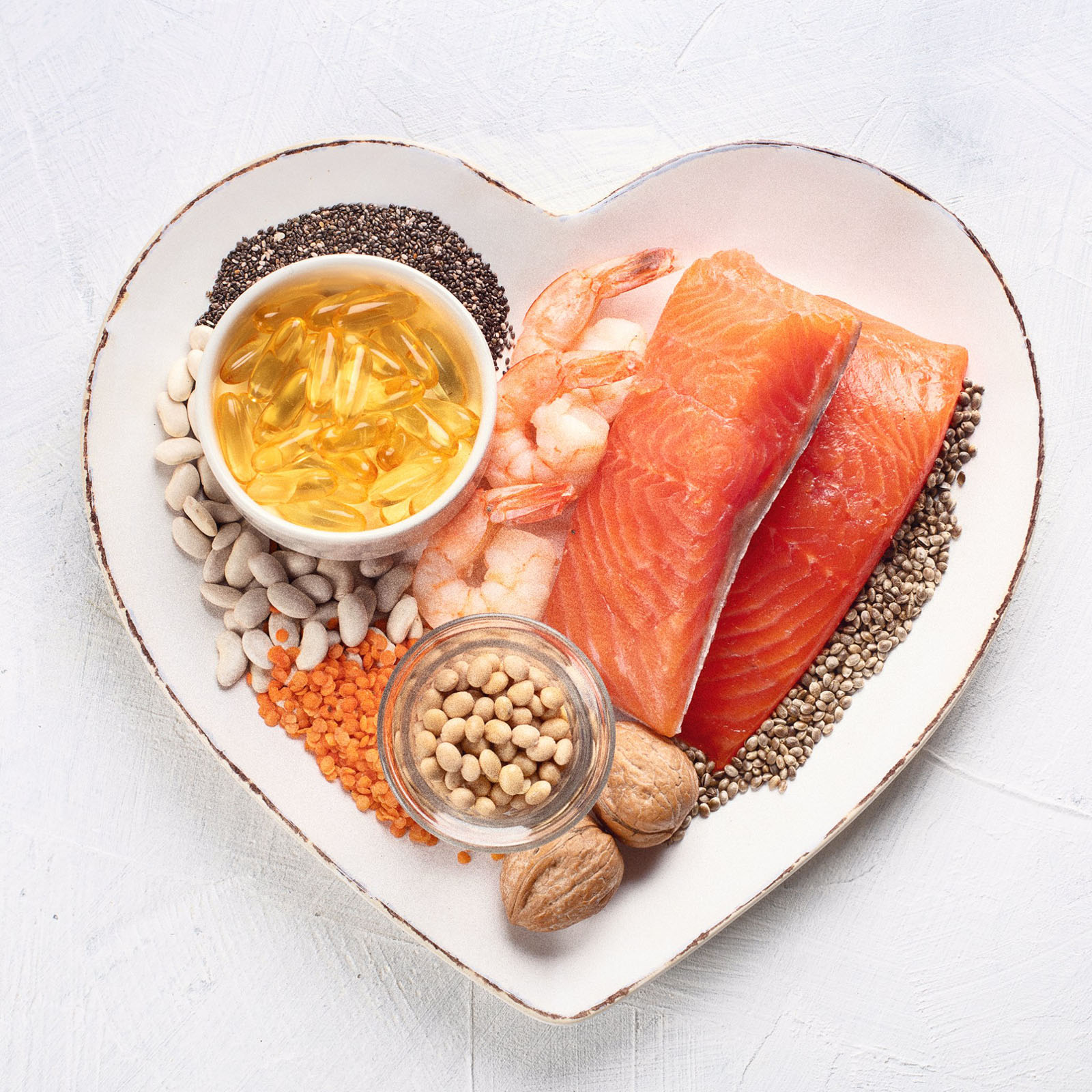 a heart-shaped plate with salmon and nuts