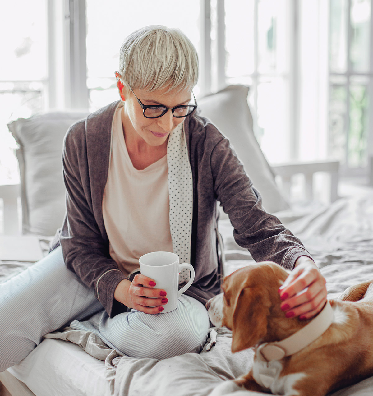 a pharmacogenomic testing patient at home patting a dog