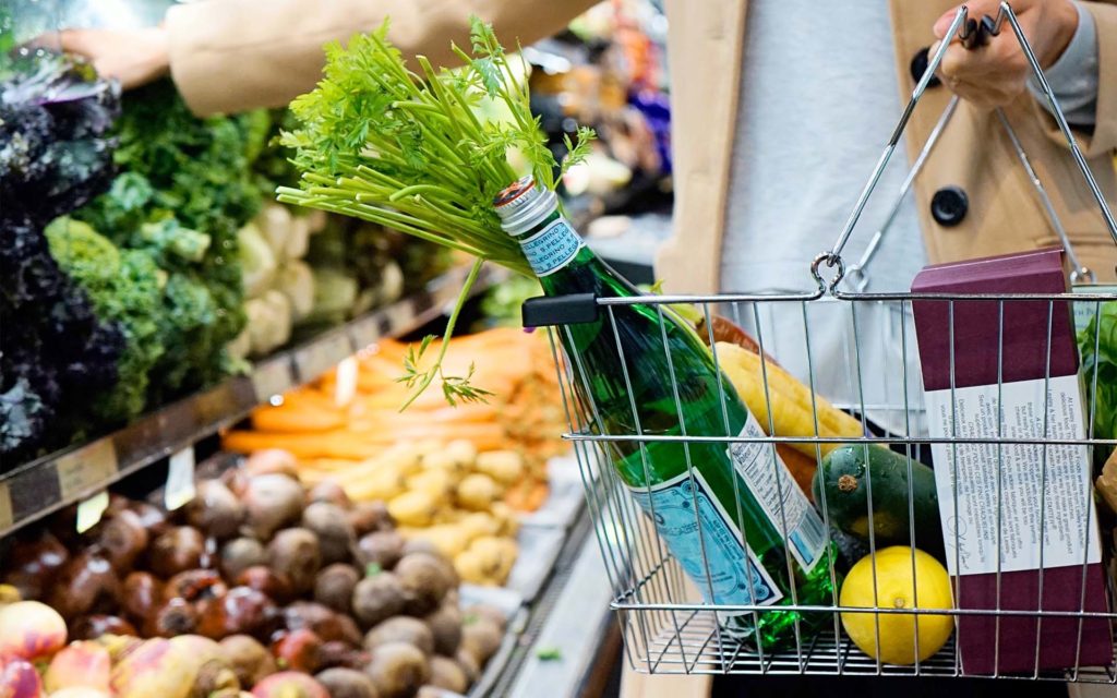 a person shopping at a supermarket for heart health food