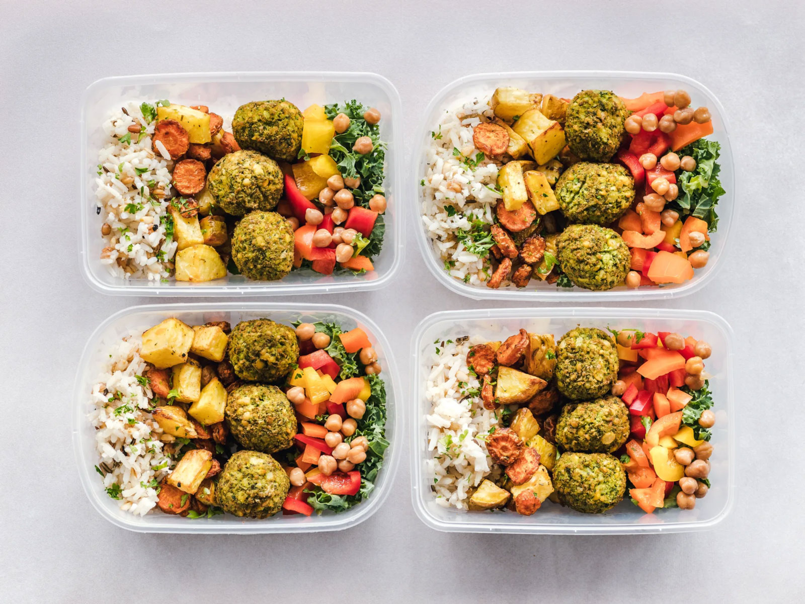 a set of 4 plastic tubs with prepared meals in each