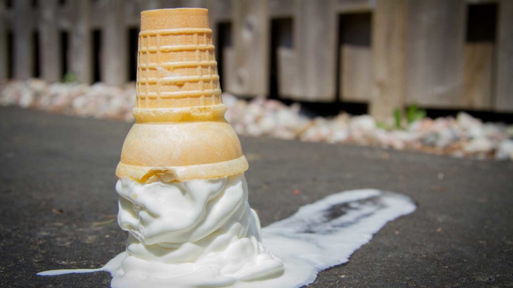 an ice cream cone dropped on the pavement