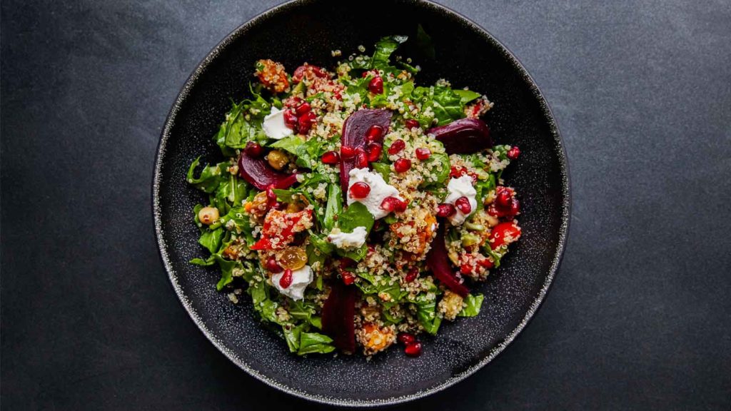 a quinoa based dish on a slate background