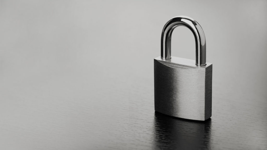 a black and white photo of a padlock showing security