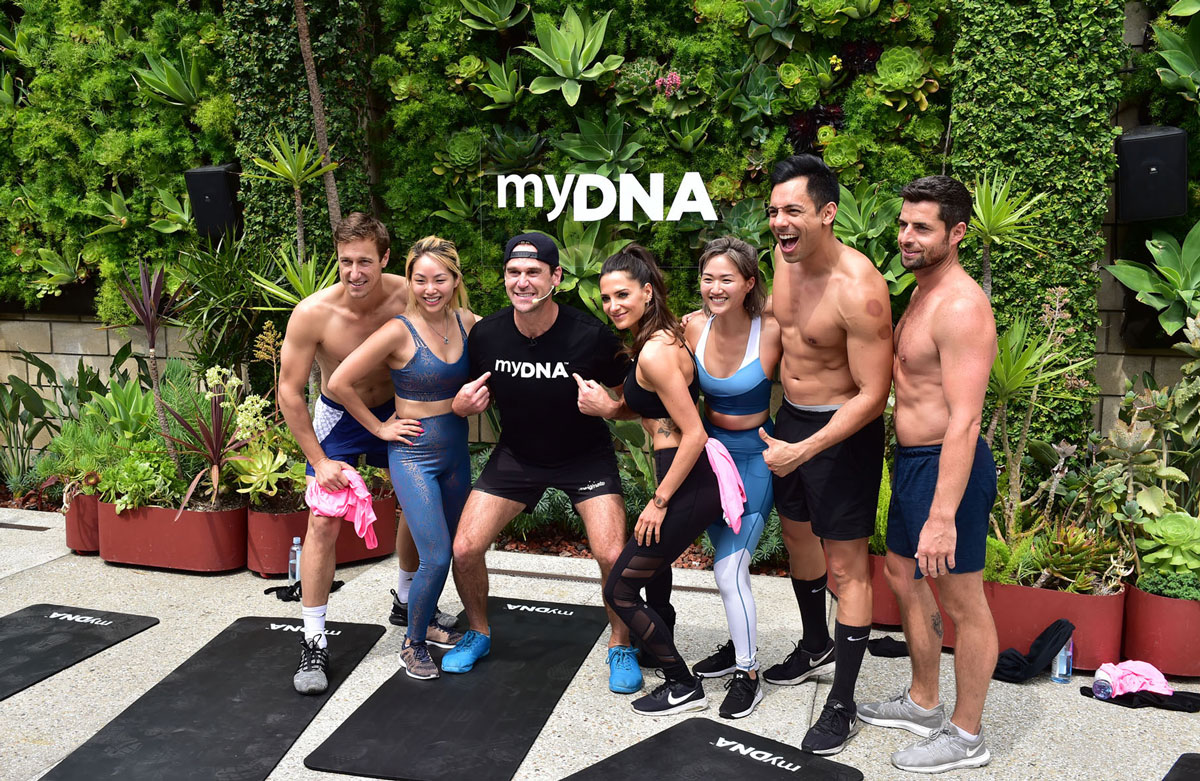 USA-Launch-event-luke-with-fitness-models Luke Milton and fitness models posing in front of the myDNA logo at the US launch event
