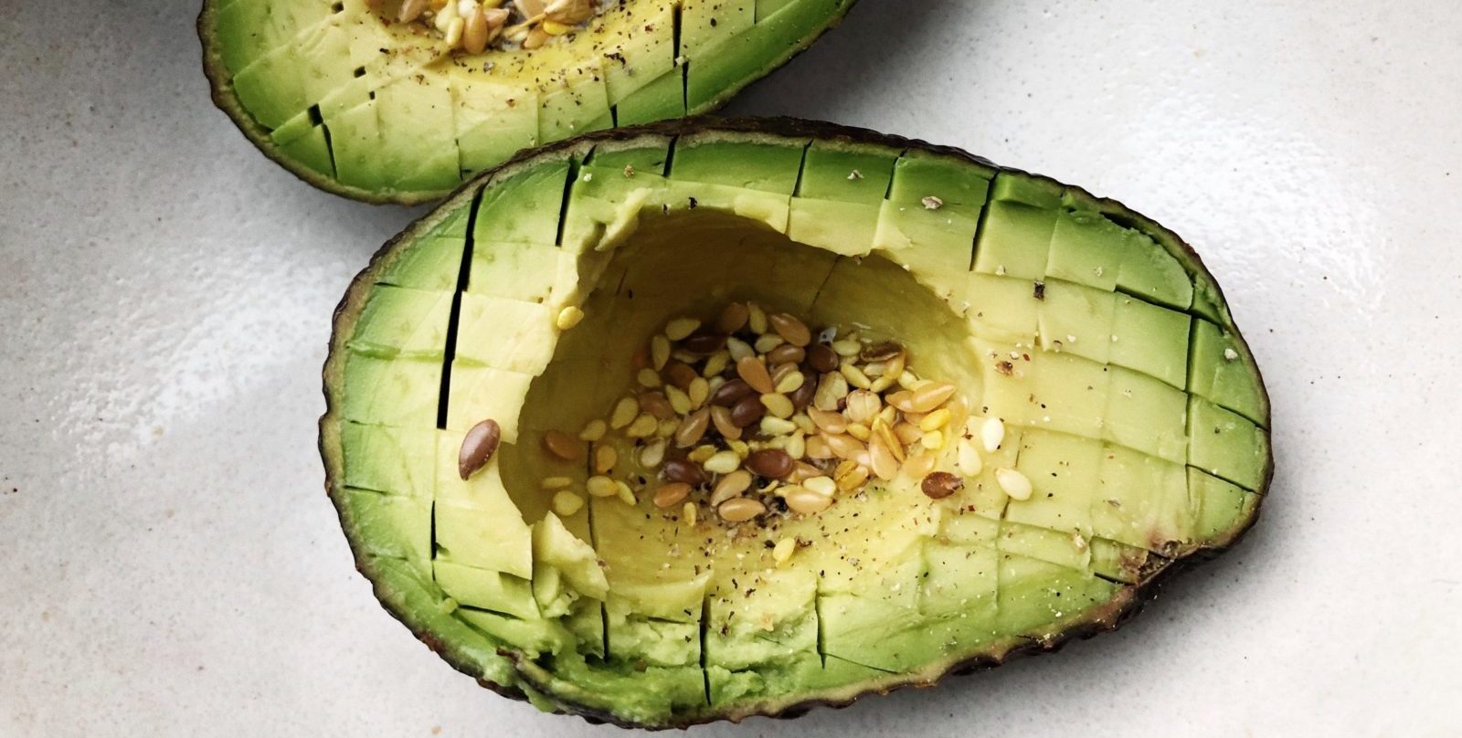 a sliced avocado on a white surface