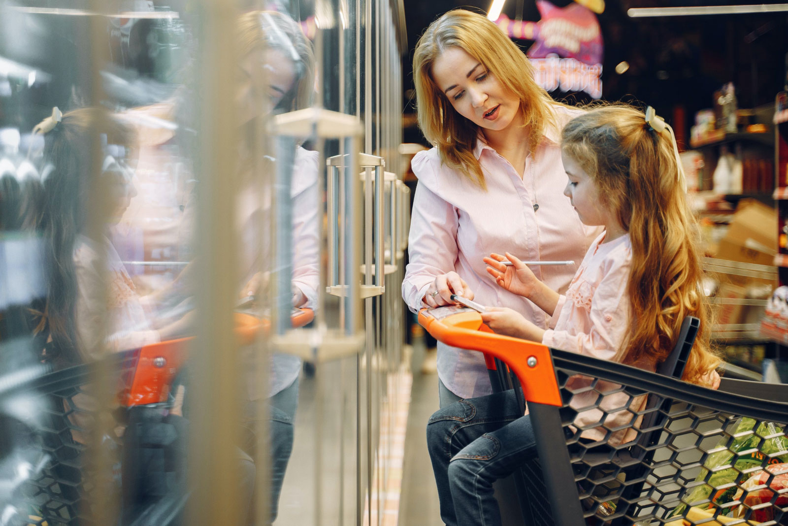 a mother and young daughter shopping together