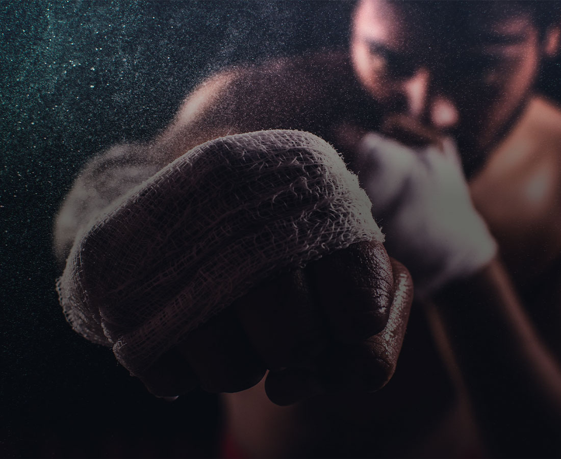 a close up shot of a boxer's hand mid-punch