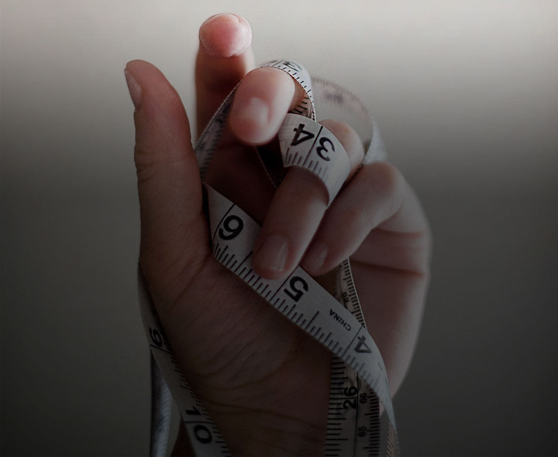 a close up shot of a hand holding a measuring tape