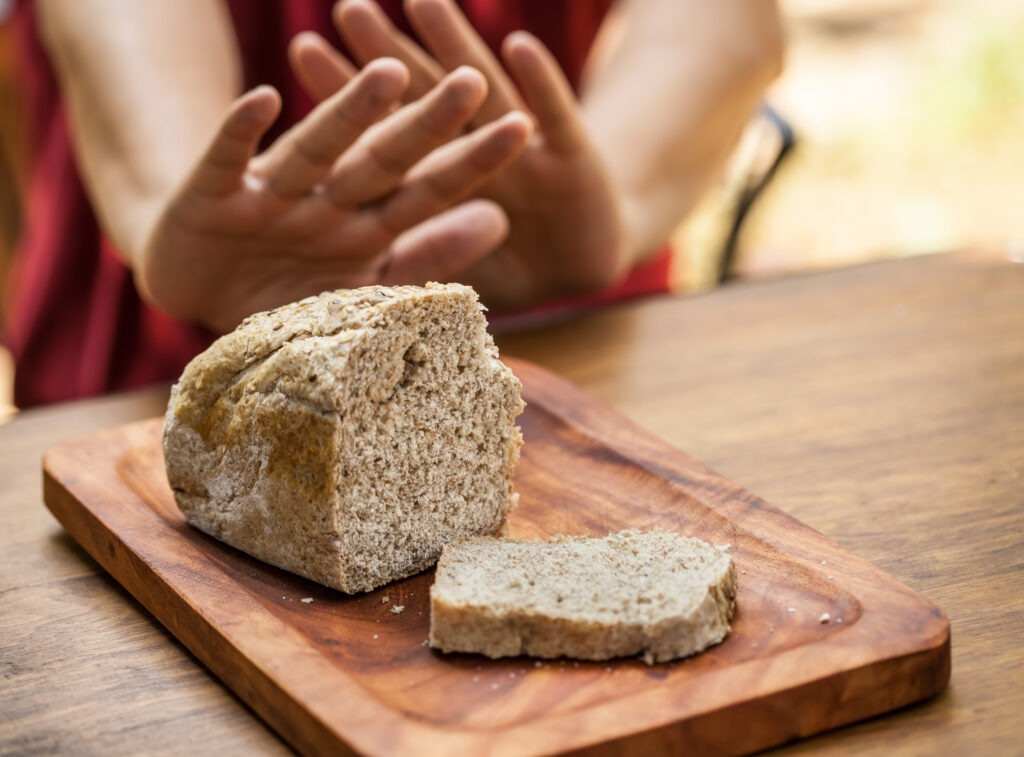 Male hands refusing or rejecting a sliced loaf of bread