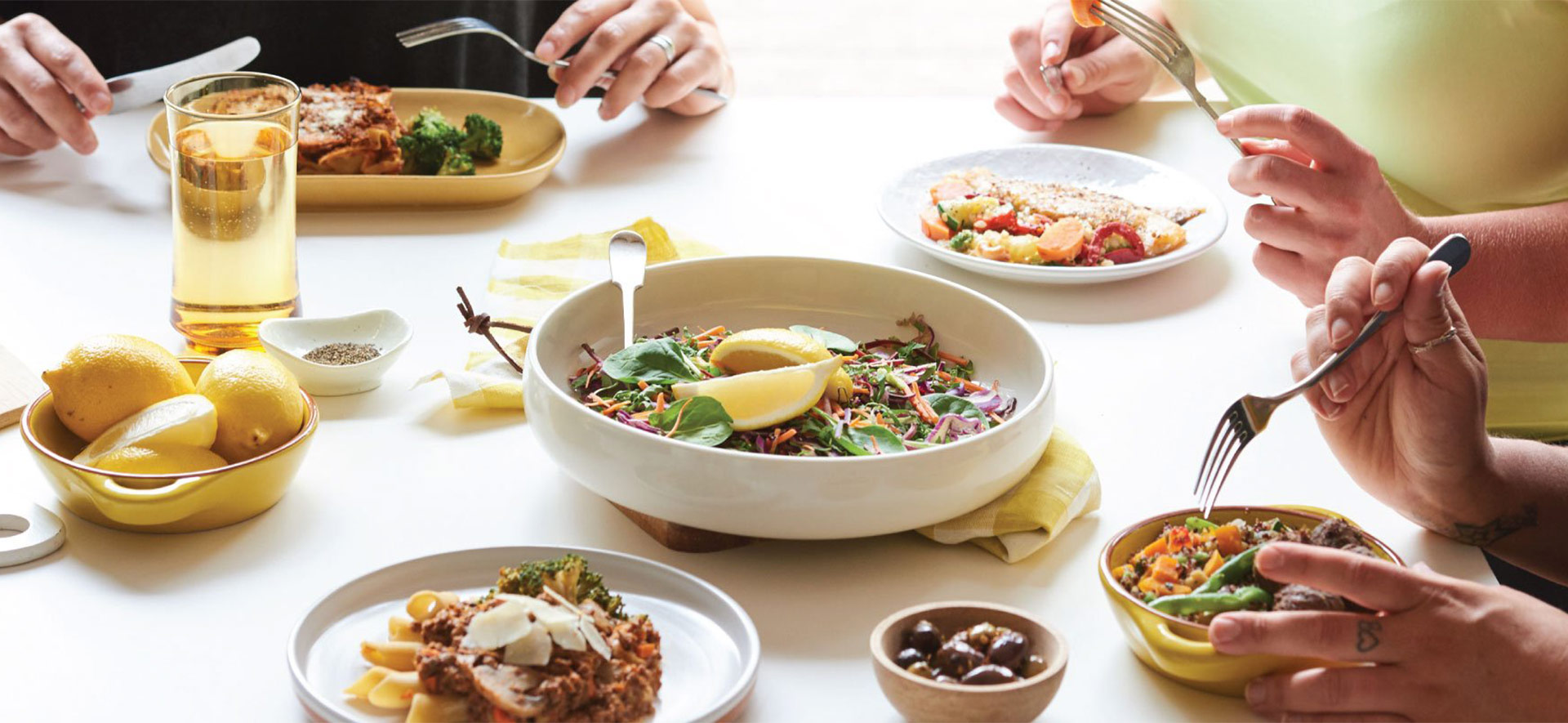 a group of people enjoying a Be Fit Food meal at a table