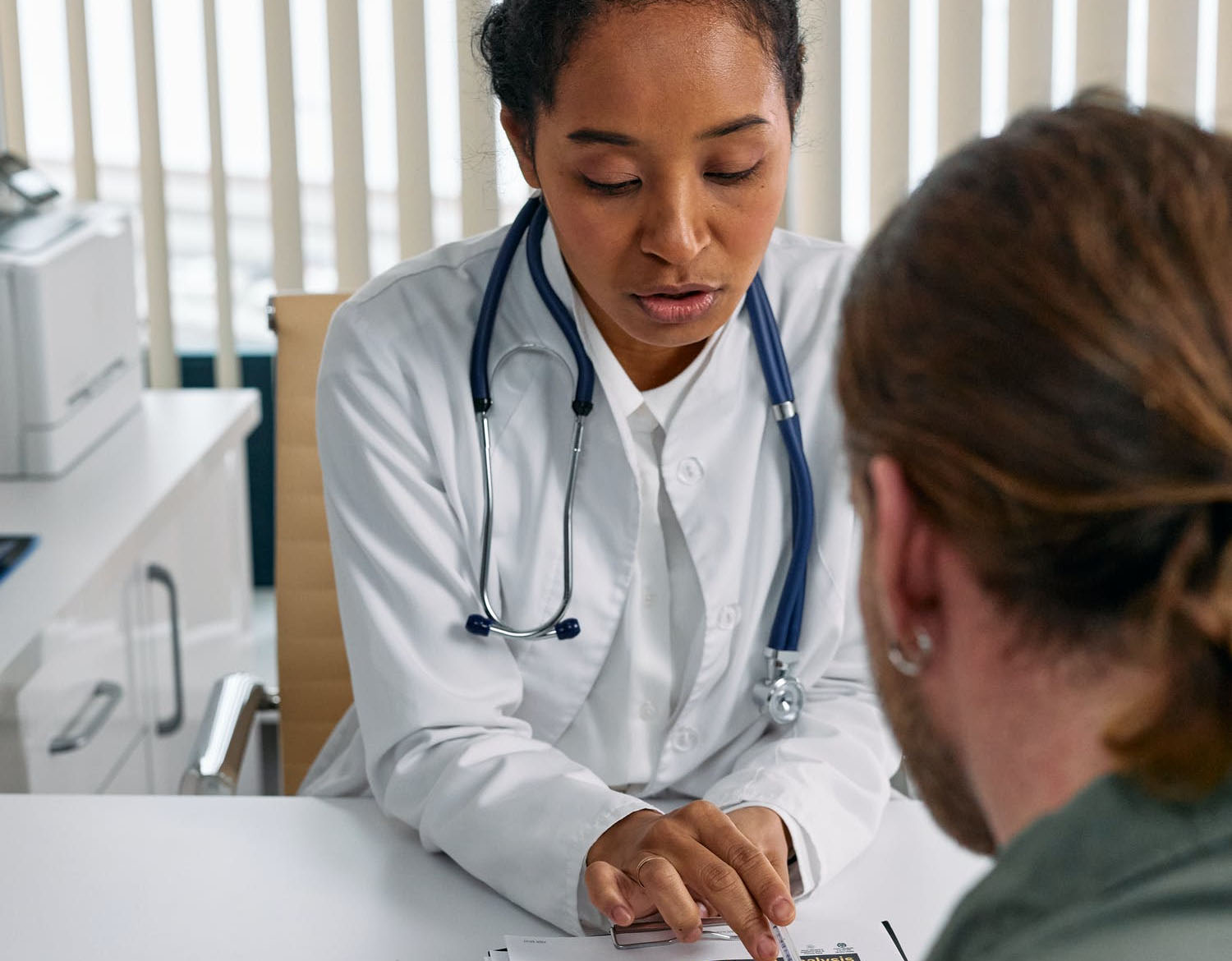 a black female doctor explaining mental health medications results