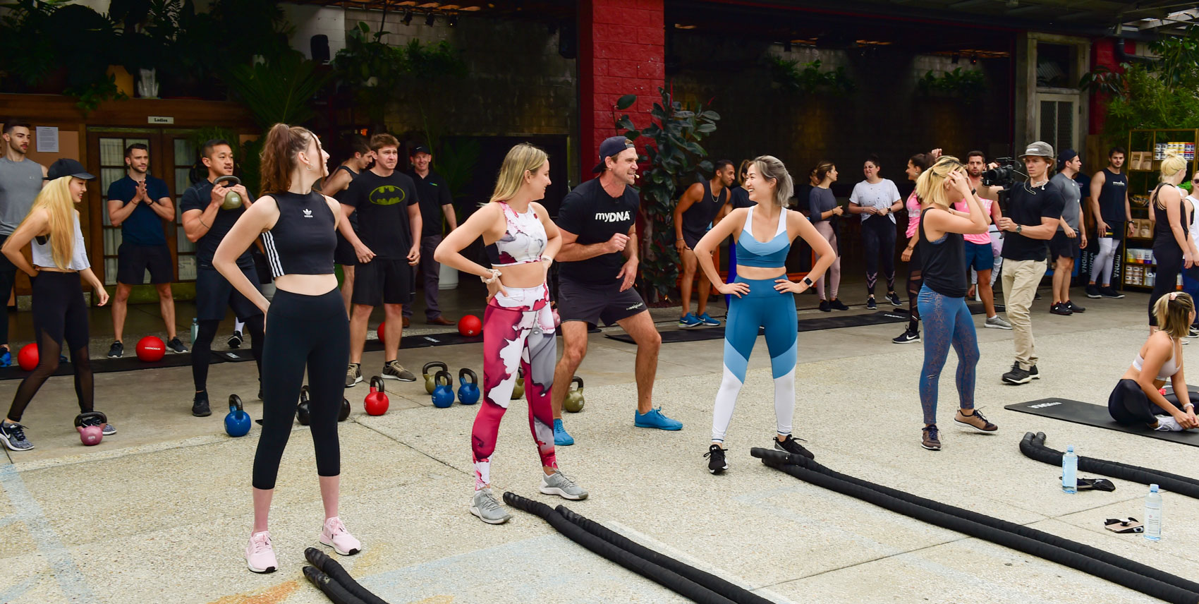 Celebrity Trainer Luke Milton and fitness influencers resting between workout sets