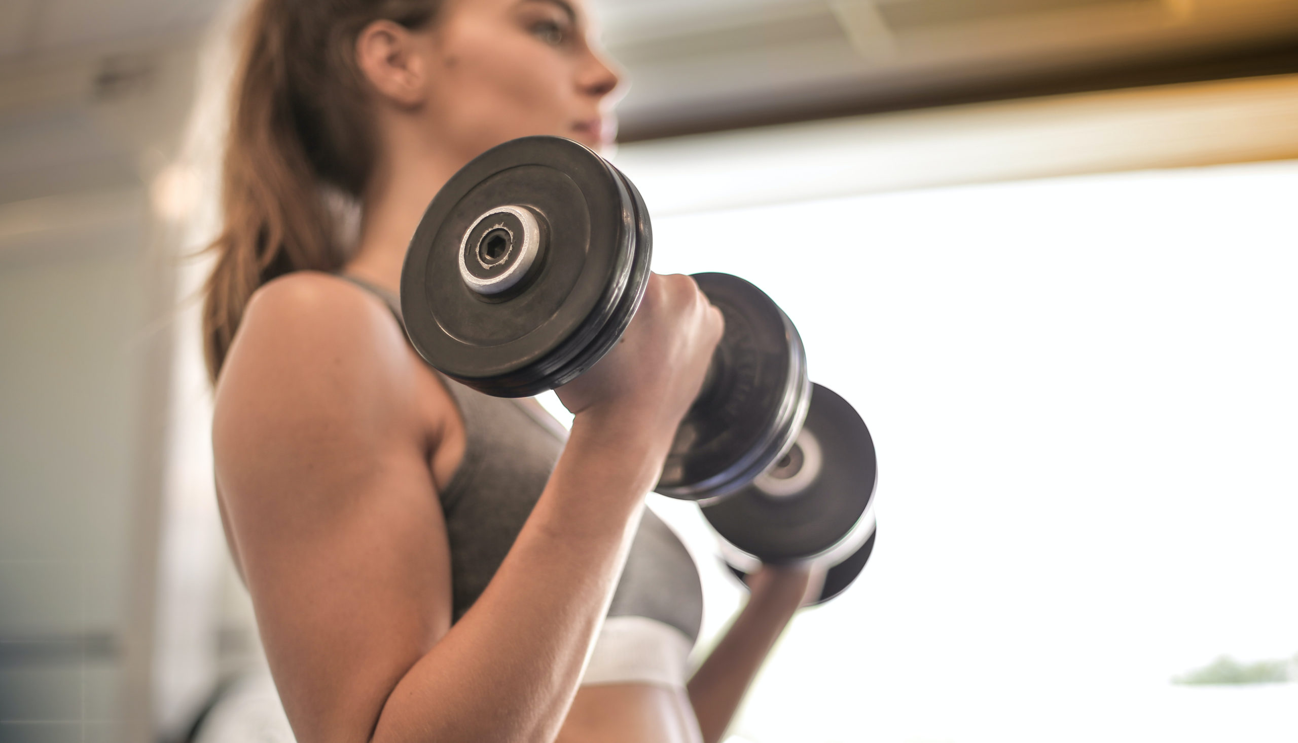 woman lifting weights power profile