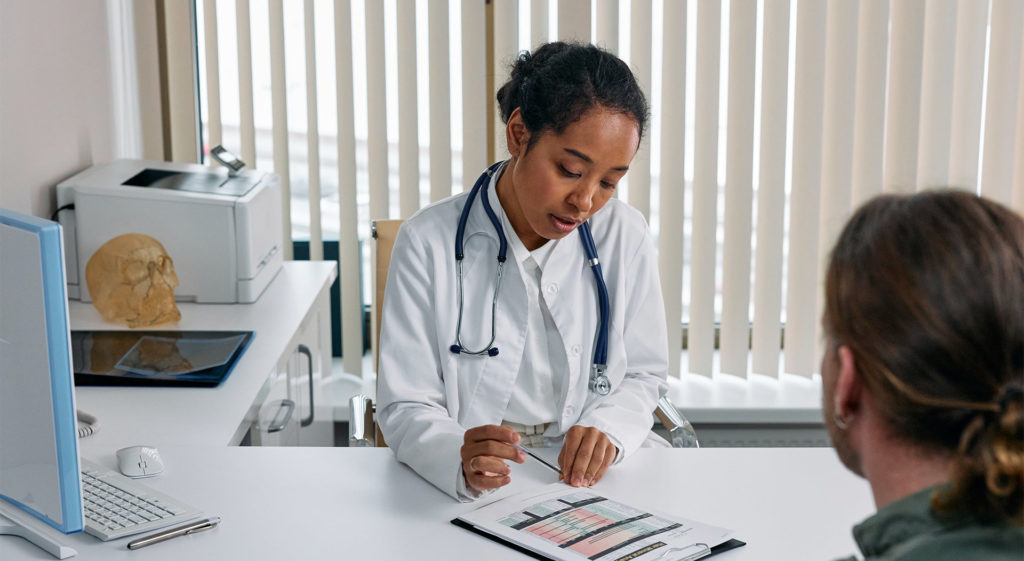 doctor discussing pharmacogenomic insurance with a patient