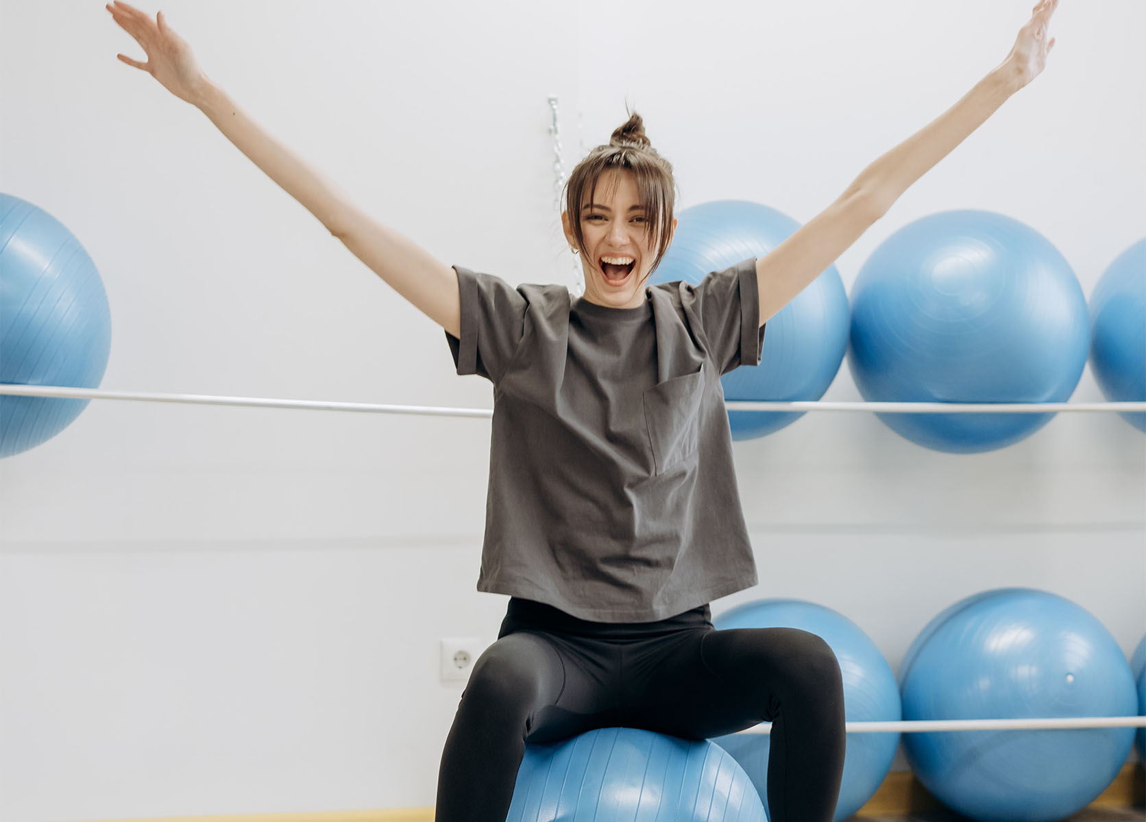 a young woman exercising for heart health on an exercise ball